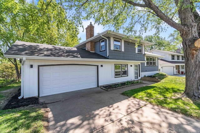 493 Rolls Rd, New Brighton, MN 55112 - view of front of home with a chimney, concrete driveway, and a garage