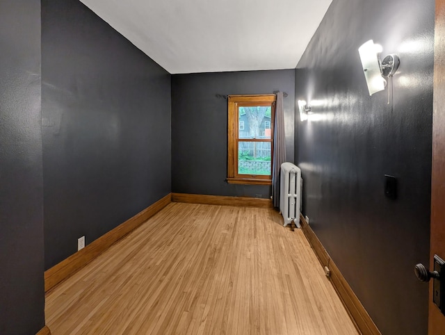 3441 Portland Ave Unit 2, Minneapolis, MN 55407 - unfurnished room featuring radiator, wood finished floors, and baseboards