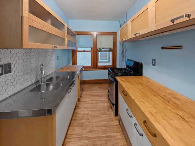 3441 Portland Ave Unit 2, Minneapolis, MN 55407 - kitchen featuring appliances with stainless steel finishes, wooden counters, a sink, and light wood finished floors