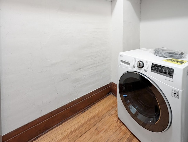 3441 Portland Ave Unit 2, Minneapolis, MN 55407 - laundry area with washer / dryer, light wood-style flooring, and baseboards