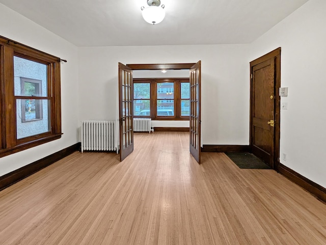 3441 Portland Ave Unit 2, Minneapolis, MN 55407 - unfurnished room featuring radiator heating unit, light wood-style flooring, and baseboards