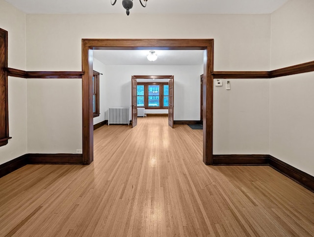 3441 Portland Ave Unit 2, Minneapolis, MN 55407 - empty room featuring radiator heating unit, light wood-style flooring, and baseboards