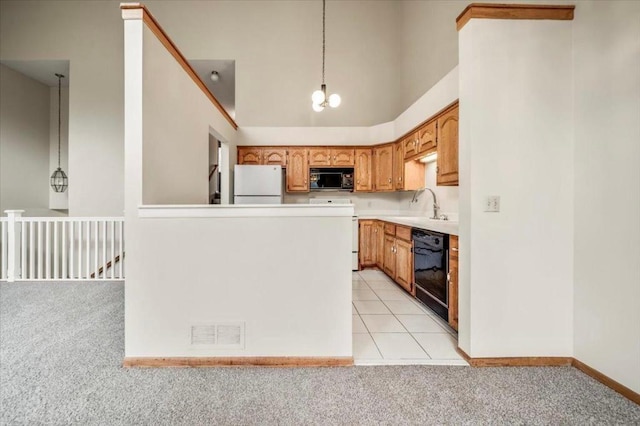 kitchen with light carpet, a sink, visible vents, a notable chandelier, and black appliances