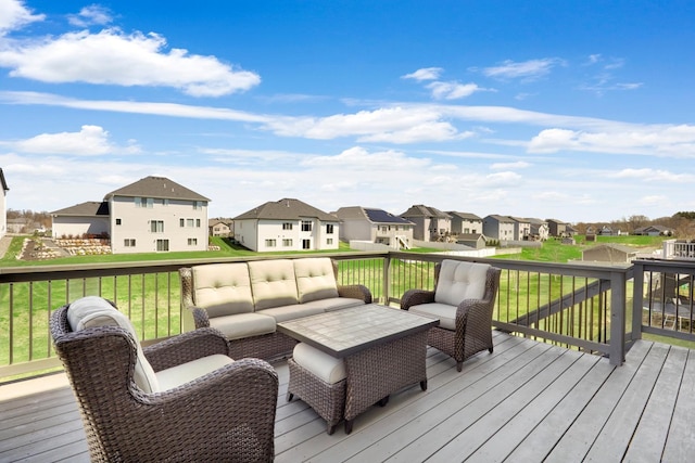 deck featuring a yard, an outdoor living space, and a residential view