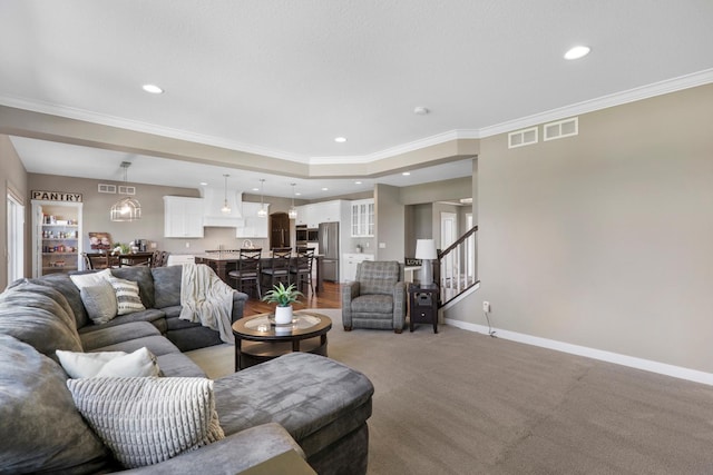 living room featuring recessed lighting, baseboards, ornamental molding, and stairs