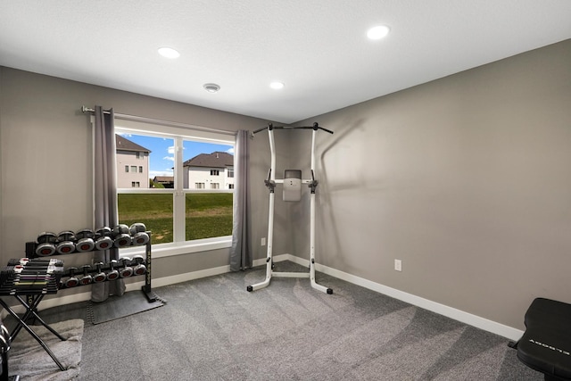 exercise area featuring recessed lighting, baseboards, and carpet