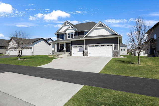 craftsman house with board and batten siding, stone siding, a front yard, and concrete driveway
