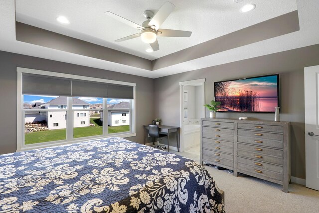 1149 167th Ave NW, Andover, MN 55304 - carpeted bedroom with a raised ceiling, a ceiling fan, and ensuite bath