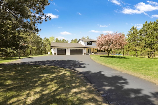 36090 Helium St NW, Wyanett Twp, MN 55371 - view of front of house featuring driveway, a front yard, and a garage