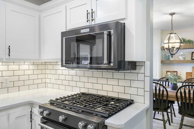 36090 Helium St NW, Wyanett Twp, MN 55371 - kitchen featuring range with gas cooktop, a chandelier, white cabinetry, light stone counters, and backsplash