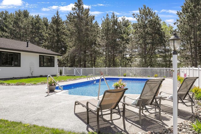 36090 Helium St NW, Wyanett Twp, MN 55371 - view of pool featuring a fenced backyard, a patio, and view of scattered trees