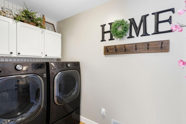 36090 Helium St NW, Wyanett Twp, MN 55371 - laundry room featuring cabinet space, washer and dryer, and a textured ceiling