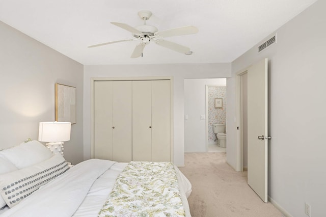 bedroom with visible vents, a ceiling fan, light carpet, a closet, and baseboards