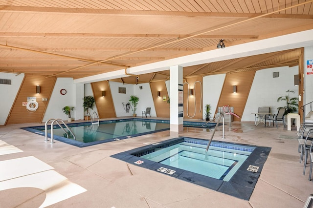 pool with a patio area and an indoor hot tub