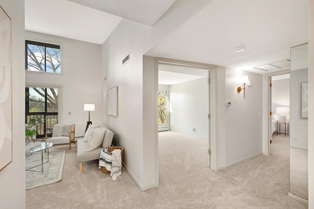 living area featuring visible vents, baseboards, and carpet