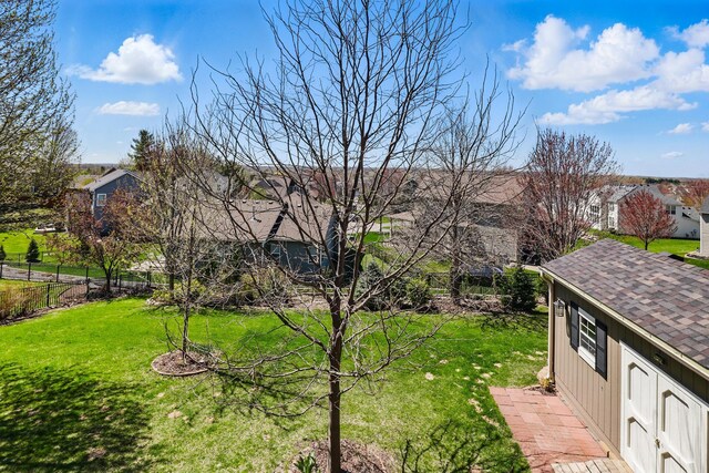 view of yard featuring fence and a residential view