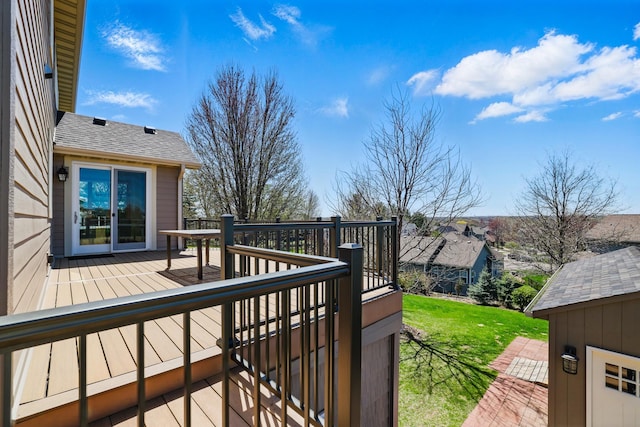 wooden deck featuring a yard