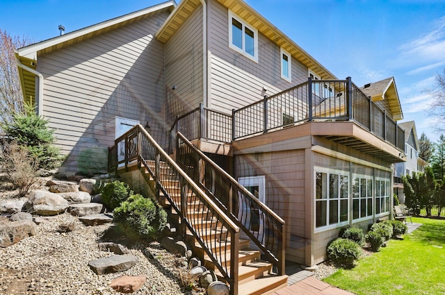 back of house featuring a wooden deck and stairway