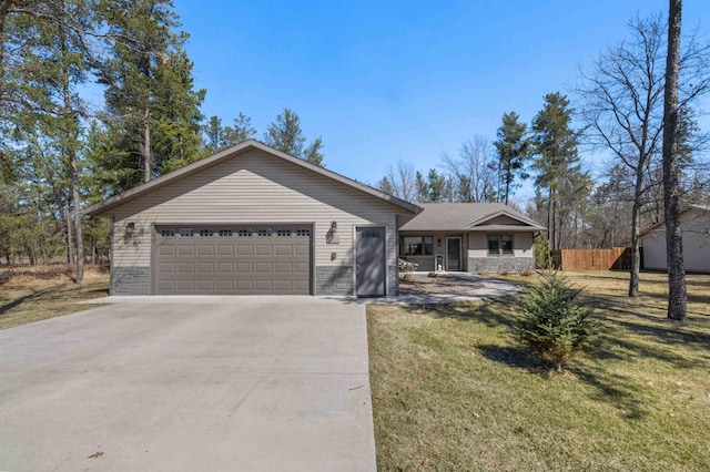ranch-style house featuring driveway, stone siding, fence, an attached garage, and a front yard