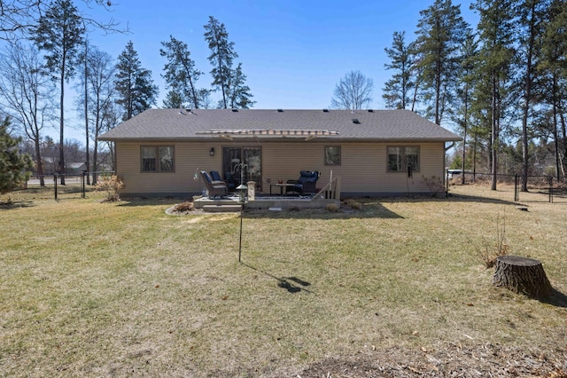 back of house with a pergola, a lawn, a fenced backyard, and roof with shingles