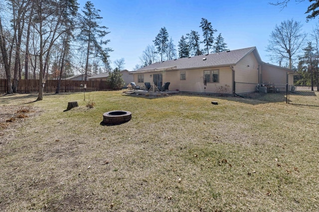 view of yard with a patio area, a fenced backyard, and an outdoor fire pit