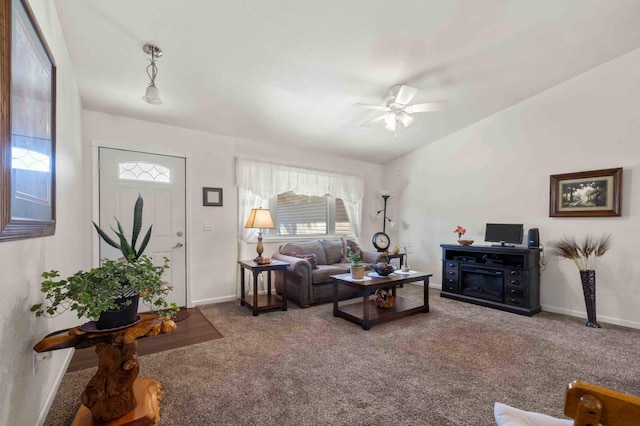 living area with carpet floors, baseboards, and ceiling fan