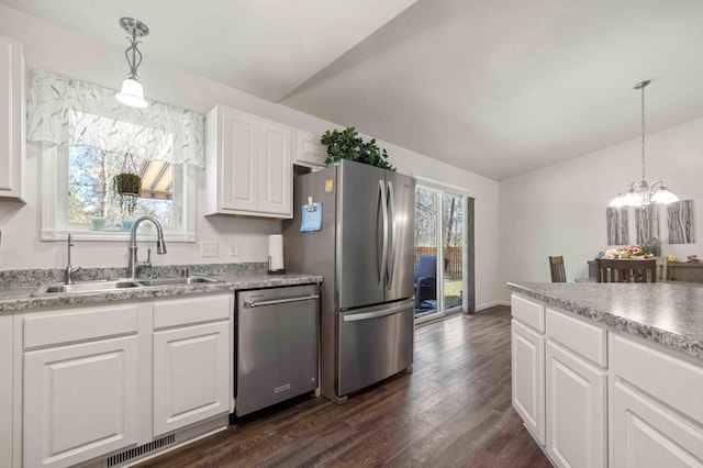 kitchen with dark wood-style floors, a sink, visible vents, lofted ceiling, and appliances with stainless steel finishes