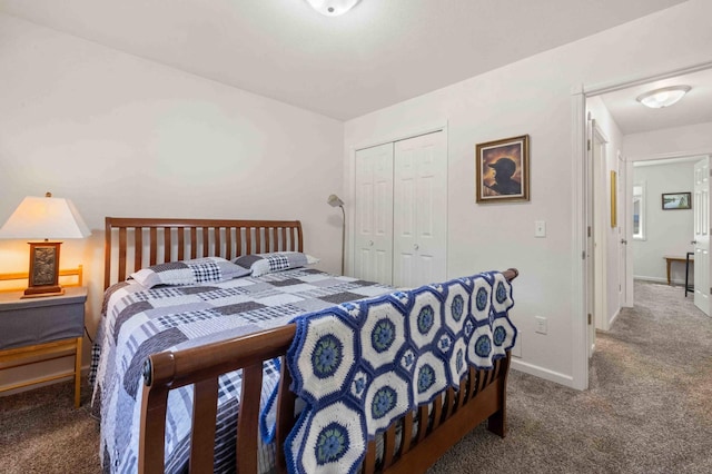carpeted bedroom featuring a closet and baseboards