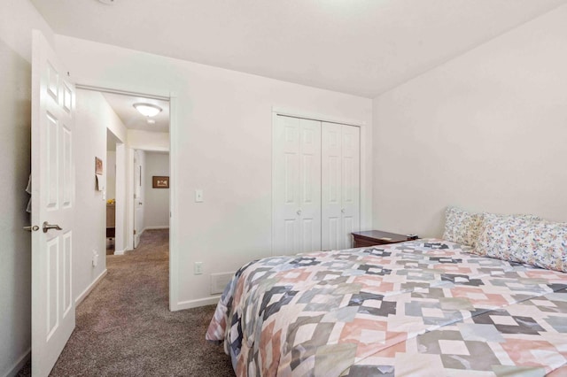 carpeted bedroom featuring a closet and baseboards