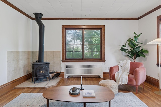 491 Burlington Rd, Saint Paul, MN 55119 - living area with radiator, a wood stove, ornamental molding, and hardwood / wood-style flooring