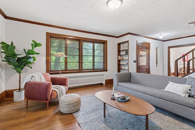 491 Burlington Rd, Saint Paul, MN 55119 - living area featuring radiator, wood finished floors, ornamental molding, and stairs