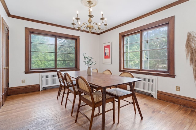 491 Burlington Rd, Saint Paul, MN 55119 - dining space with radiator, a chandelier, light wood finished floors, and ornamental molding