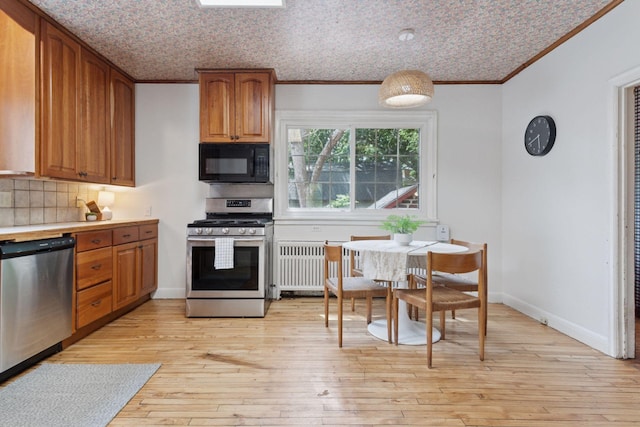 491 Burlington Rd, Saint Paul, MN 55119 - kitchen featuring stainless steel appliances, radiator, crown molding, backsplash, and brown cabinets