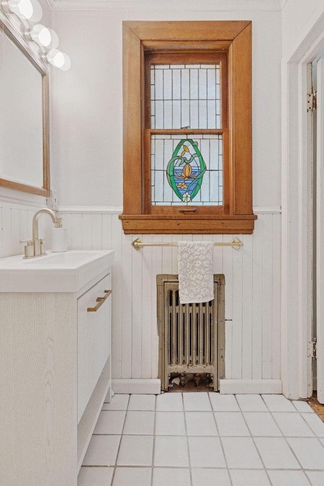 491 Burlington Rd, Saint Paul, MN 55119 - bathroom featuring radiator heating unit, vanity, and a wainscoted wall