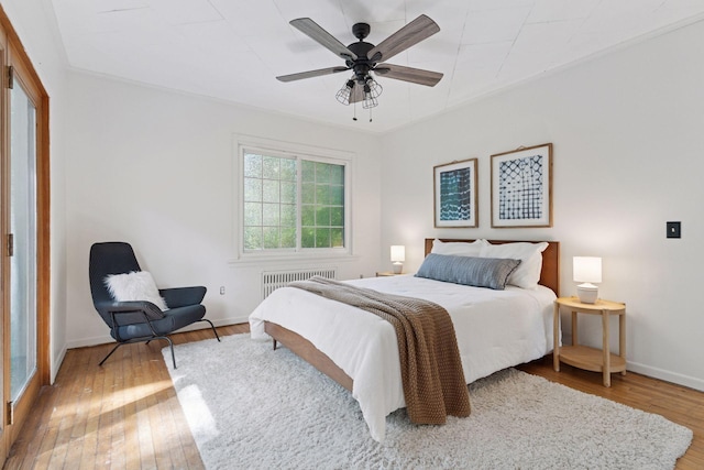 491 Burlington Rd, Saint Paul, MN 55119 - bedroom with hardwood / wood-style flooring, radiator, and ceiling fan