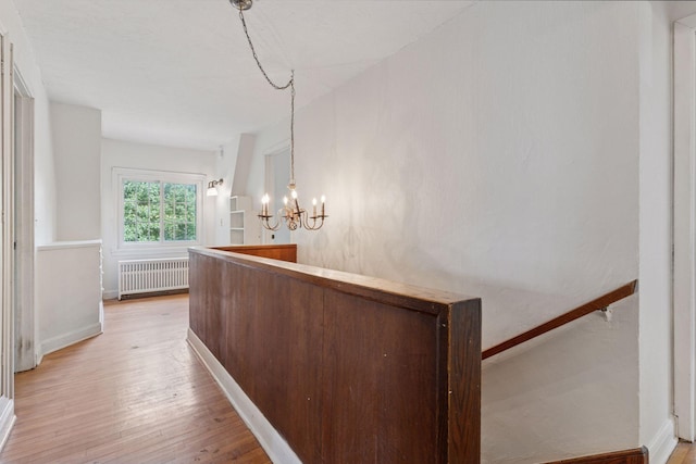 491 Burlington Rd, Saint Paul, MN 55119 - hallway with radiator, a chandelier, and light wood-style floors