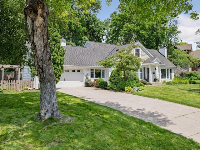 5048 Kent Ave, Edina, MN 55436 - view of front of home featuring a chimney, concrete driveway, a garage, and roof with shingles