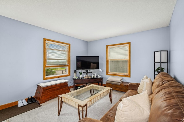 carpeted living area featuring baseboards