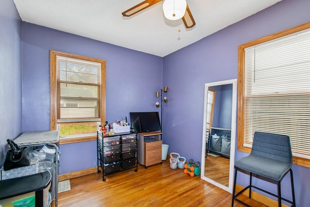 game room with baseboards, ceiling fan, and wood finished floors
