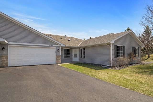 8569 Telford Ln N, Brooklyn Park, MN 55443 - ranch-style house featuring driveway, an attached garage, a front lawn, and roof with shingles