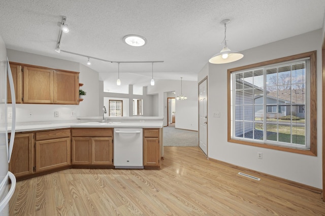 8569 Telford Ln N, Brooklyn Park, MN 55443 - kitchen featuring white appliances, a sink, a peninsula, light wood finished floors, and brown cabinets
