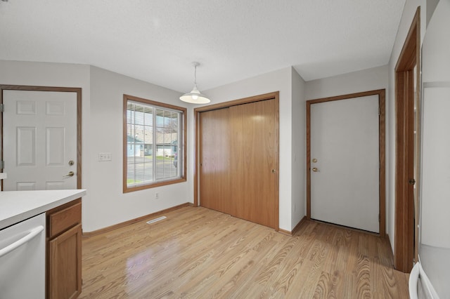 8569 Telford Ln N, Brooklyn Park, MN 55443 - foyer with light wood-style flooring, baseboards, and a textured ceiling