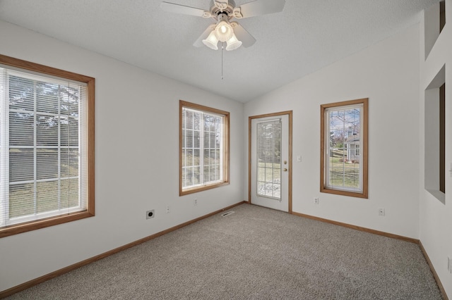8569 Telford Ln N, Brooklyn Park, MN 55443 - empty room with light carpet, baseboards, lofted ceiling, and a ceiling fan