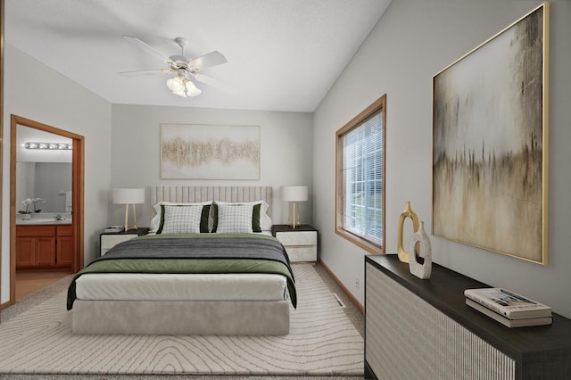 8569 Telford Ln N, Brooklyn Park, MN 55443 - carpeted bedroom with connected bathroom, baseboards, and a ceiling fan