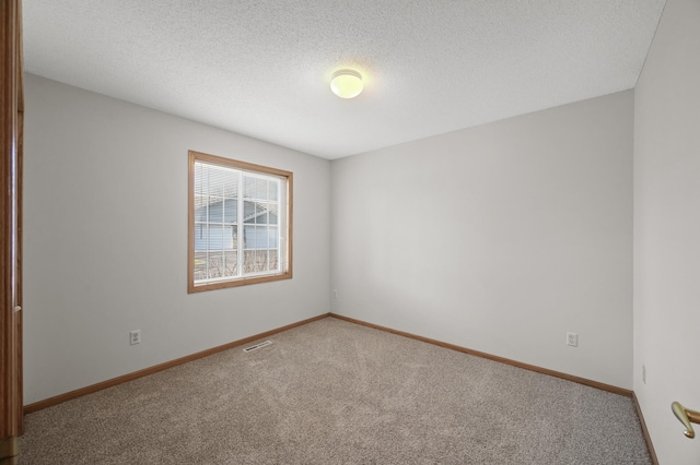 8569 Telford Ln N, Brooklyn Park, MN 55443 - unfurnished room featuring carpet, baseboards, and a textured ceiling