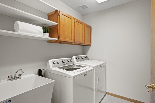 8569 Telford Ln N, Brooklyn Park, MN 55443 - washroom featuring cabinet space, independent washer and dryer, baseboards, light flooring, and a textured ceiling