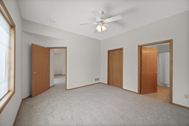8569 Telford Ln N, Brooklyn Park, MN 55443 - unfurnished bedroom with carpet floors, baseboards, and ceiling fan