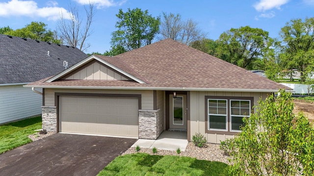 17729 Everest Ave, Lakeville, MN 55044 - view of front of home featuring board and batten siding, an attached garage, driveway, a shingled roof, and stone siding