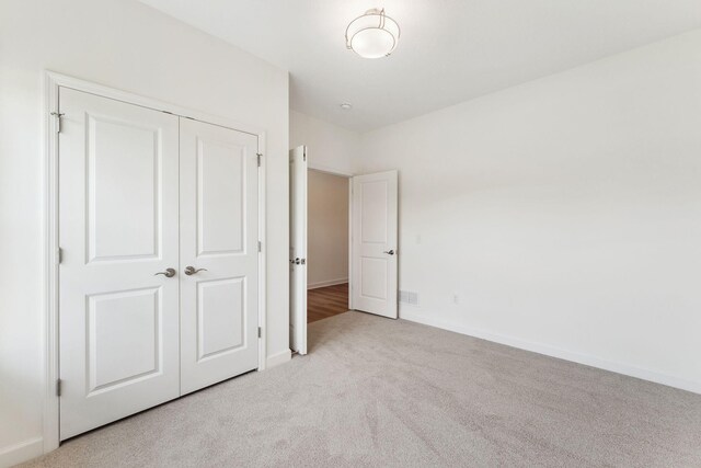 17729 Everest Ave, Lakeville, MN 55044 - unfurnished bedroom with light carpet, a closet, and baseboards