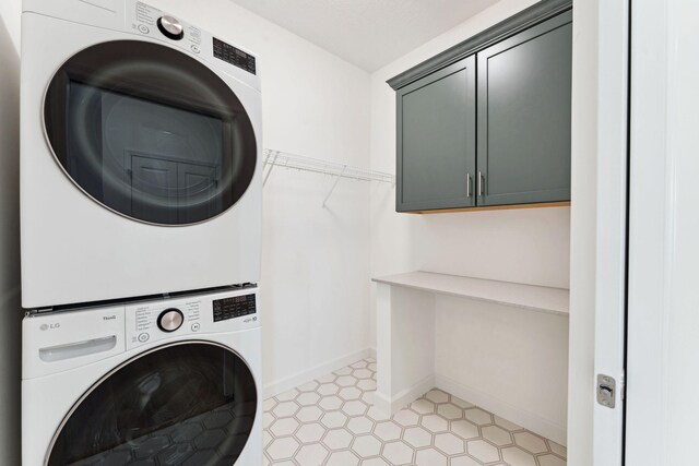 17729 Everest Ave, Lakeville, MN 55044 - washroom with stacked washer / drying machine, cabinet space, and baseboards